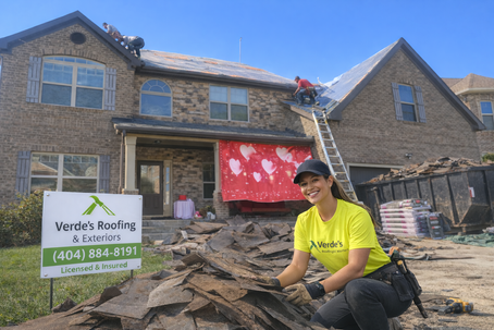 Completed residential roof replacement on two-story brick home in Brookhaven, GA by Verde’s Roofing & Exteriors featuring new shingles and clean landscaping.
