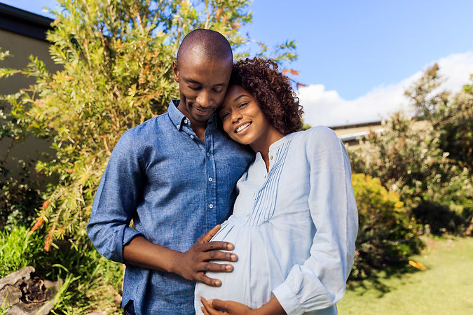 Black pregnant happy couple with hand on bump