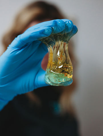 image of aesthetician wearing blue gloves with alexandria professional sugaring paste at drip iv wellness & Medspa