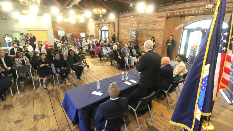 A speaker addressing an audience at the Train Depot.