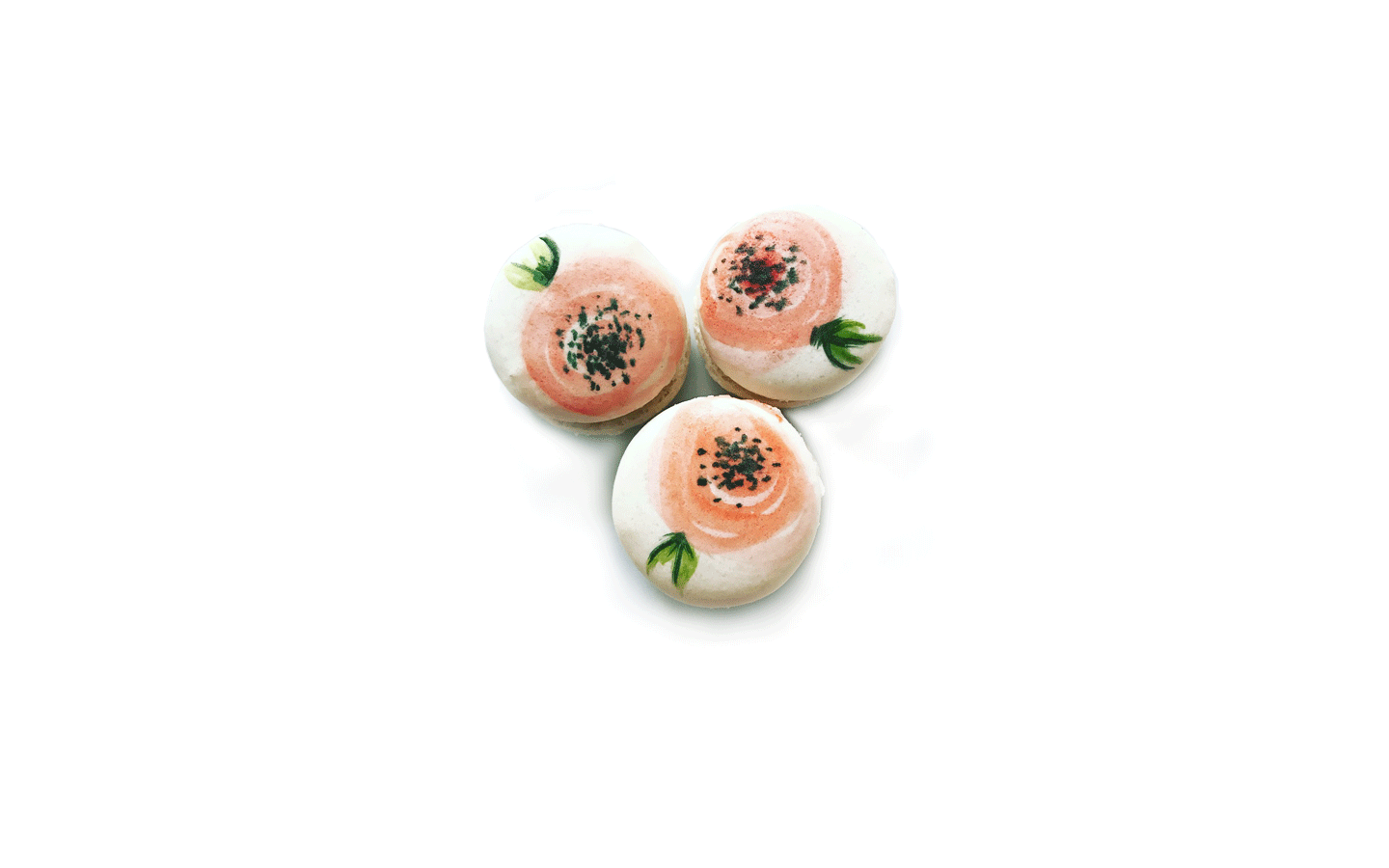 three macarons with orange poppy flowers painted on top