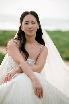Bride with natural bridal makeup and soft waves photographed outdoors in Phuket