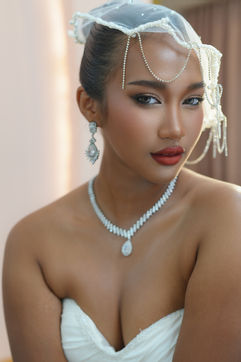 Bride with deep skin tone wearing elegant bridal makeup and a sleek updo