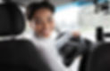 driver-turns-to-passenger-seat-and-smiles-at-camer-2022-12-16-08-25-51-utc.jpg