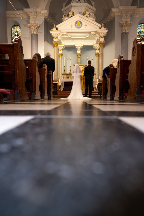 Bride and groom at the altar in church for a wedding ceremony.