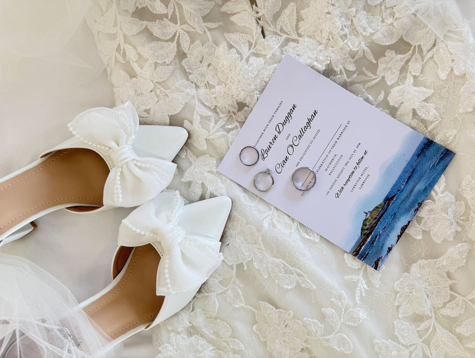 Wedding shoes and rings with a wedding invitation; Lauren & Cian White Amber Photography
