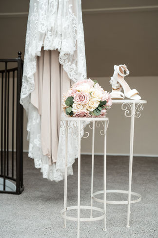 Wedding dress, shoes, and bouquet on display; White Amber Photography – Cork Wedding.