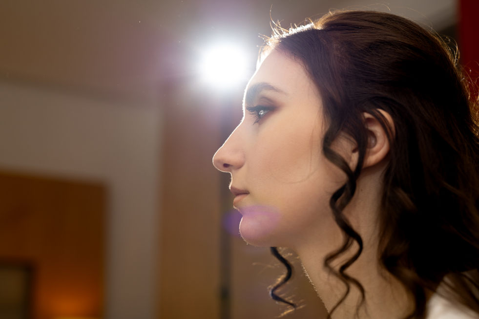 Profile of elegant woman with curly hair, in bright light, White Amber Photography