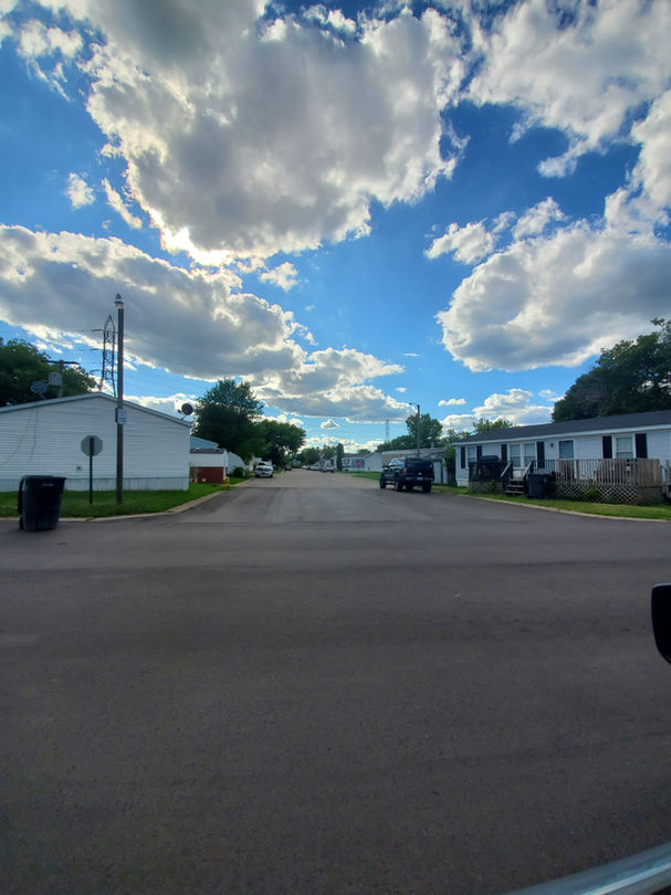 Walton Manor Mobile Home Community street filled with beautiful mobile homes.