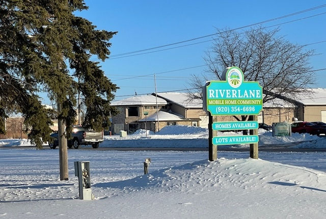 Riverlane entrance sign with snow on the ground.