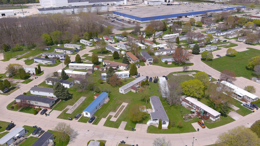 Community view of home homes and surrounding area in University Village Heights Mobile Home Community.