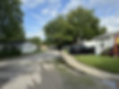 street of mobile homes with cars in driveways