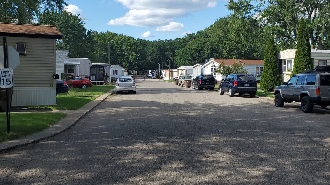 Walton Manor Mobile Home Community with mobile homes and green trees located in Pontiac, MI.