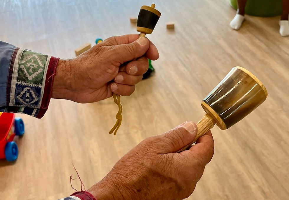 man holding two Haudenosaunee Rattles