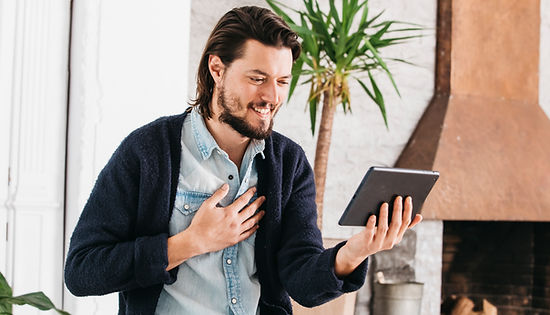 portrait-smiling-young-man-making-video-call-using-digital-tablet.jpg