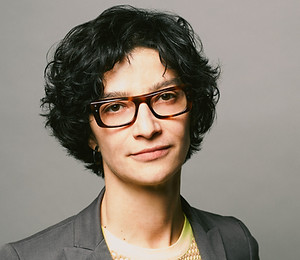 headshot of a woman with glasses and short dark hari