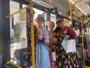 Four people dressed in colourful clothing on a Perth bus
