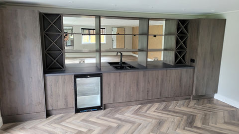 Modern bar units tht also house tall boiler and integrated fridge