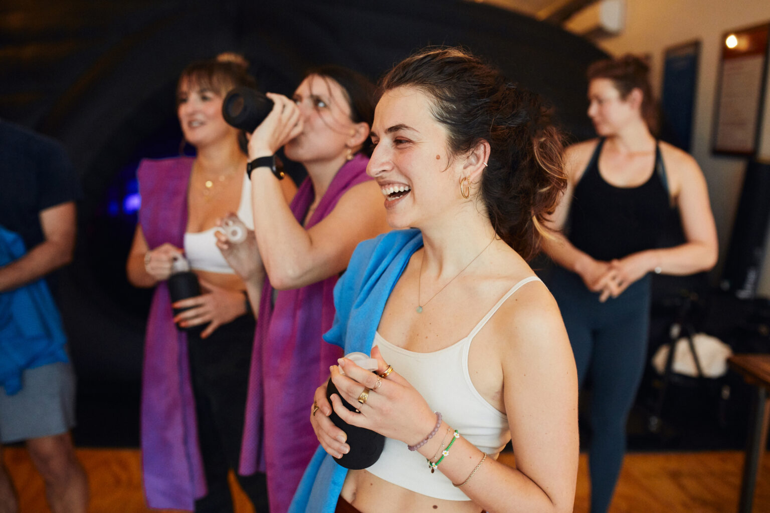 People chatting and smiling after a Hotpod Yoga class