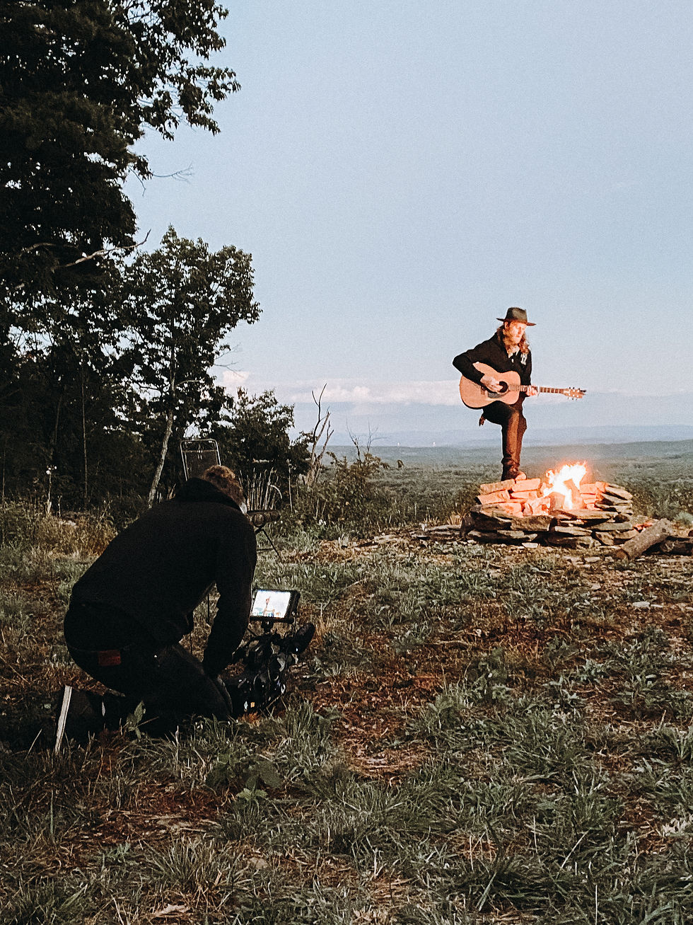 The Lumineers singing at campfire for Triumph Motorcycles video shoot.