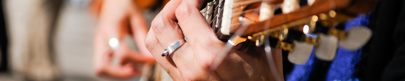 Man hands playing the Spanish guitar.jpg