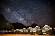Private sleeping tents in camp Wadi Rum under starry ceiling