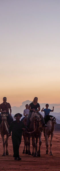 Family during camel ride in Wadi Rum