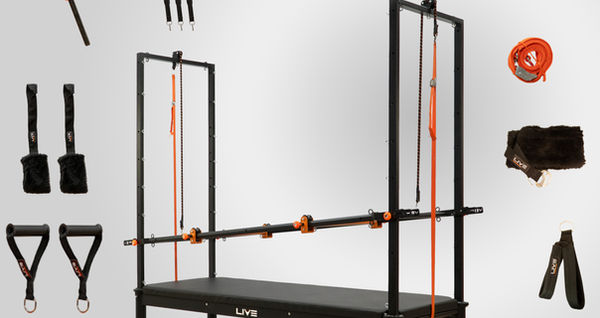 Complete Pilates Cadillac setup with various accessories including straps, bars, and cushions.
