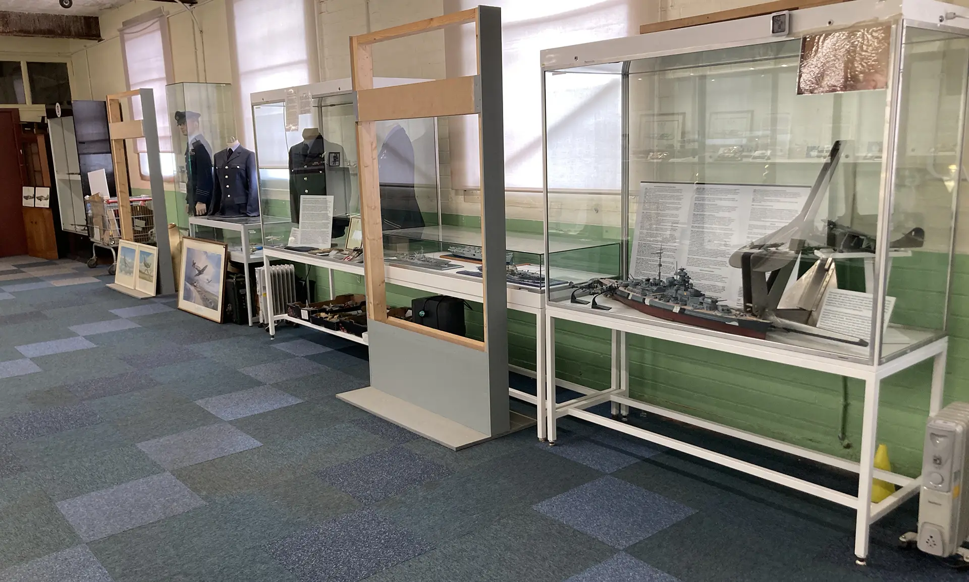 Military Uniforms and Display cabinets in the Ernie Cromie Second World War Room at the Ulster Aviation Society