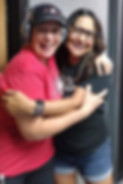 Two West Valley Women Veterans members smiling and embracing at a community event.