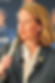 Woman speaking into a microphone during a West Valley Women Veterans leadership event.