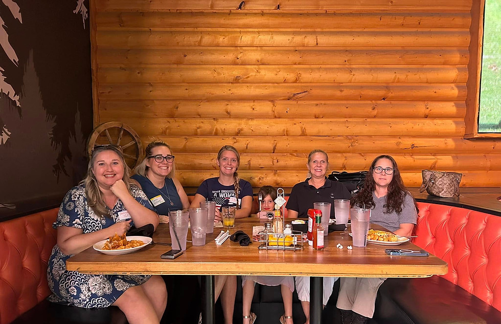 Five West Valley Women Veterans members sharing a meal at a community brunch.