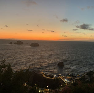 Sunset over the Pacific Ocean and rocky coastline in Mazatlán, Mexico.