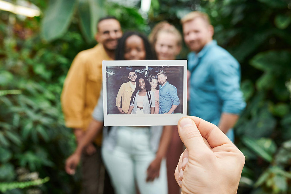 Friends take photo with polaroid camera.