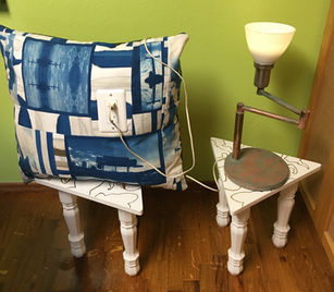 Billboard ad pillow, electric outlet, lamp, tables