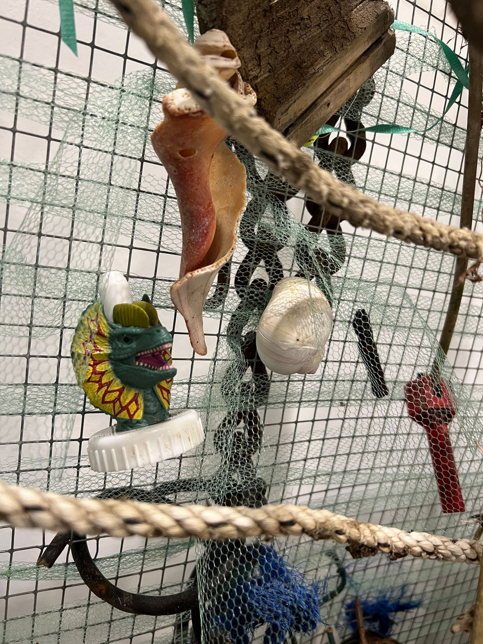 sculpture detail with dinosaur drink top and chain