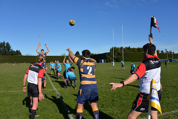 CRRA assistant referee raising a flag on the touchline during a rugby match