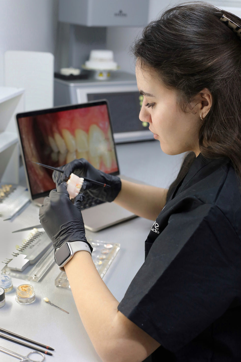 Dental technician designing a custom dental restoration using digital lab software