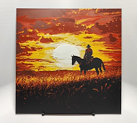 Cowboy on horse silhouette against vibrant sunset