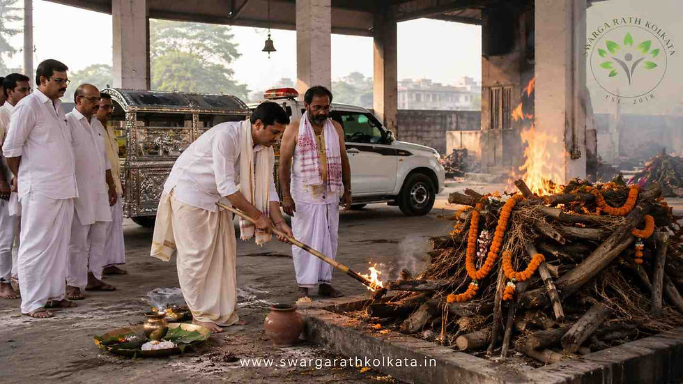 The chief mourner performing the Mukhagni ritual during a traditional Bengali Hindu cremation ceremony in Kolkata under priest guidance.