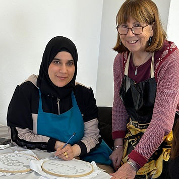 Workshop members Waed and Sue. Sue has written ‘friend’ in Arabic in soya wax on her Batik and Waed is checking that it’s correct. Workshop members Waed and Sue. Sue has written ‘friend’ in Arabic in soya wax on her Batik and Waed is checking that it’s correct. Workshop members Waed and Sue. Sue has written ‘friend’ in Arabic in soya wax on her Batik and Waed is checking that it’s correct. Workshop members Waed and Sue. Sue has written ‘friend’ in Arabic in soya wax on her Batik and Waed is checking that it’s correct. Workshop members Waed and Sue. Sue has written ‘friend’ in Arabic in soya wax on her Batik and Waed is checking that it’s correct.