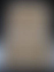 Two baking trays with unbaked triangular pastries, filled with strawberry, apricot, and chocolate, on parchment paper labeled with filling names.