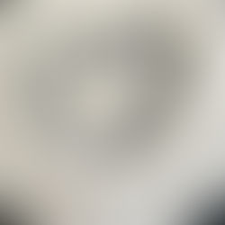 Flour arranged in a heart shape on a dark surface, creating a contrast. The texture of the flour adds a soft, artistic feel.