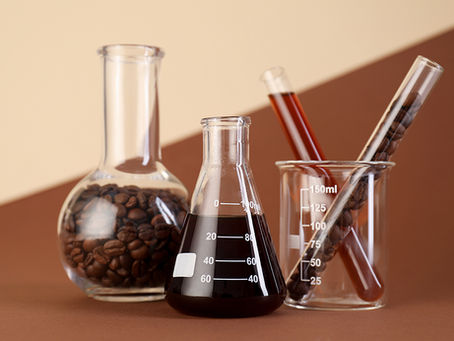 Image of coffee beans and coffee in scientific glasses
