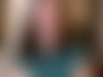 Emily Jackson smiles broadly, wearing a teal green button-up