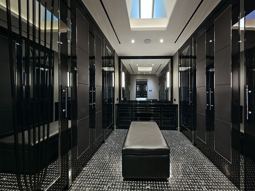 ‘his’ walk-in wardrobe area with large mirror and skylight