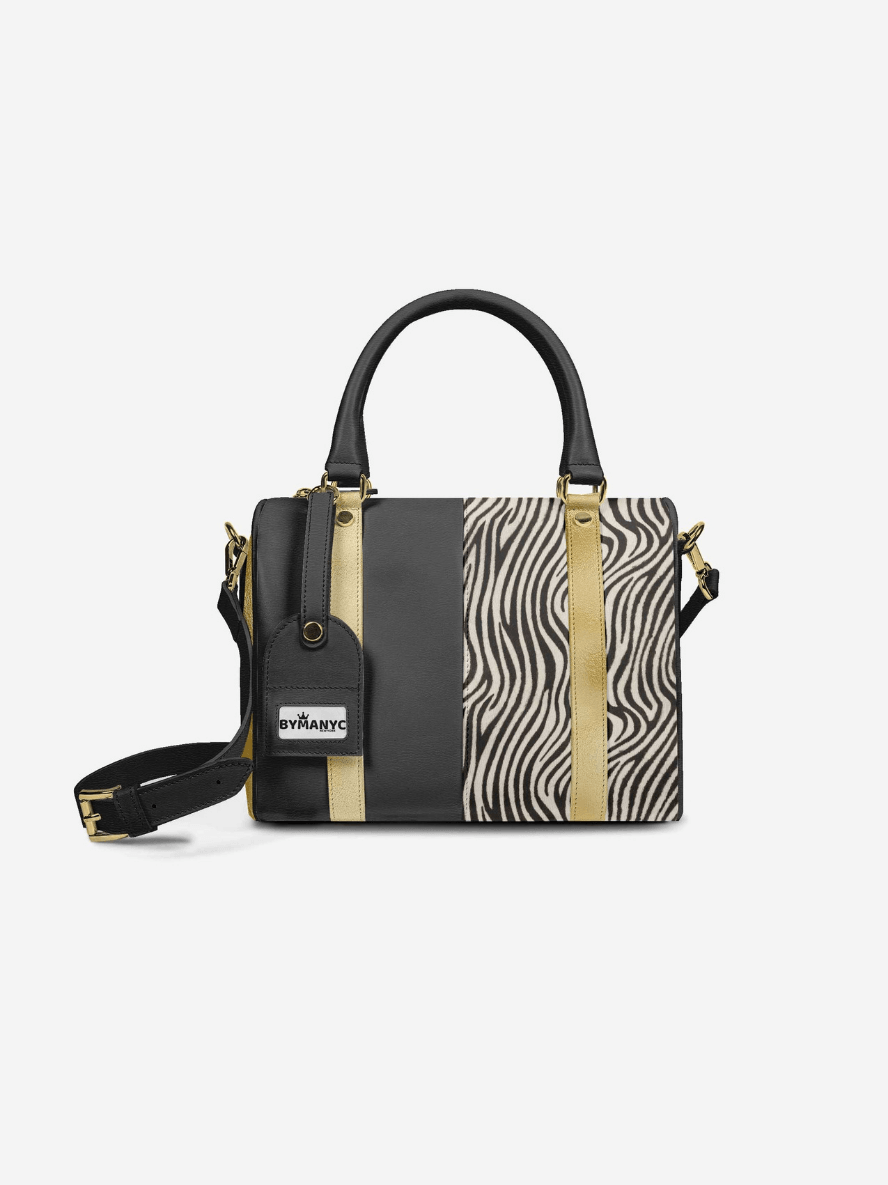 Zebra print handbag with black and gold accents on a white background.