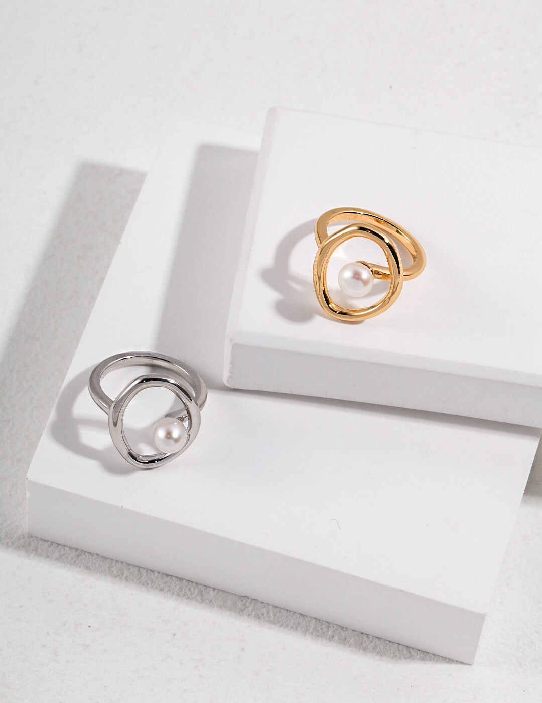 Two rings with pearls on white background, jewelry product photography.