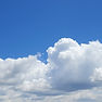 Light blue sky with fluffy clouds.jpg