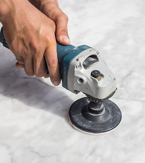 man-polishing-marble-stone-table-by-small-angle-grinder.jpg